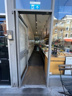 Single glass door in grey wooden frame. Push grey wooden handle from right to open.