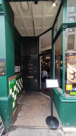 Opening ahead to entrance at back. Welcome sign on right.