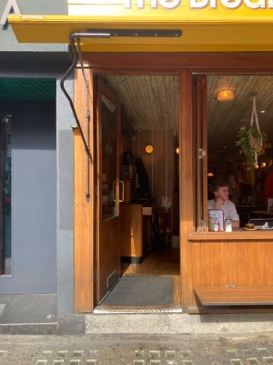 Access via wooden door with glass panel. Push open via metal handle on right.