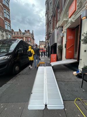 From right of entrance facing left. Venue then entrance on right. First ramp ahead goes up to connecting landing ahead.