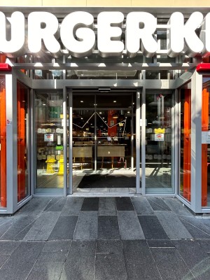 Double automatic sliding doors with silver frames.