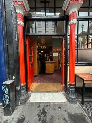 Red and glass panelled doors. Push gold panels in centre to open.