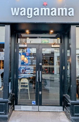 Front entrance.
Manual doors.
Tables and chairs either side of entrance.