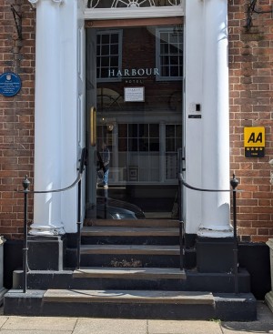 Front entrance.
Stone steps.
Hand rails on both sides of steps.
Glass door.