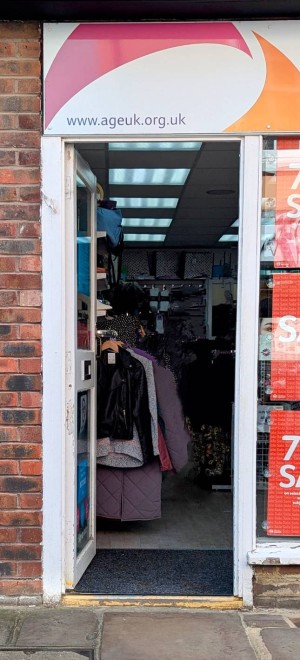 Front door.
Push to open manual door.
Merchandise, clothes rack to left of entrance.