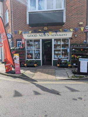 Front entrance.
A boards and advertising flags on pavement outside.
Planters either side of the door.