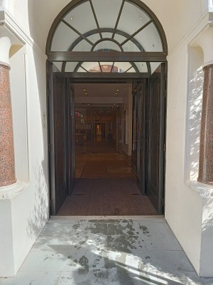 Brown doors with brown metal handles in the middle. Push to open.