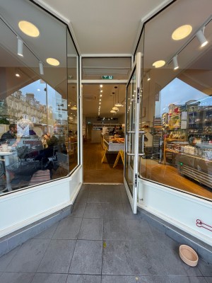 From side walk facing venue. Archway ahead. Door at back.