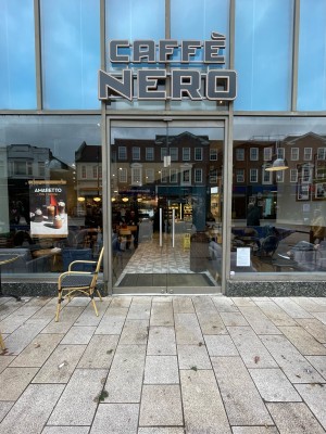 From street facing entrance. Metal framed glass doors ahead. Push silver vertical handles in centre to open inwards.