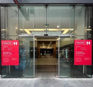 Glass doors with thin silver frame. Doors slide outwards to open.