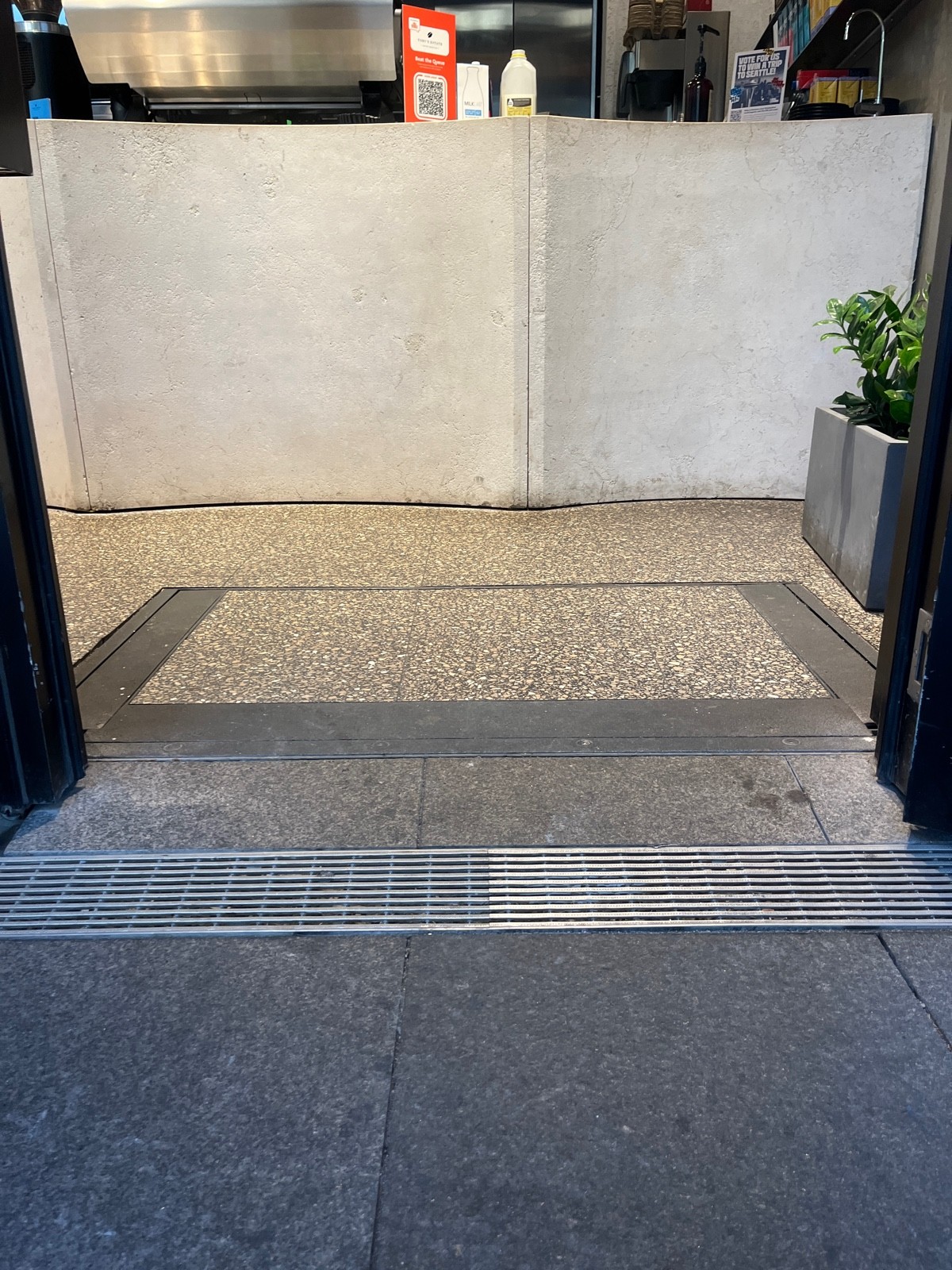 Small bump before door followed by small built in ramp.