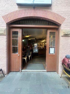 Brown wooden double doors with glass panels. Push from middle to open.