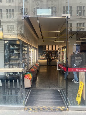 Access via glass door. Push open via metal handrail on left.