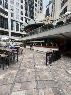 Open archway leading to bar directly ahead. Divider to right. Seating either side.