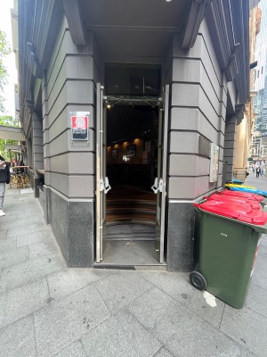 Glass double doors with olive green frame. Push from middle to open.