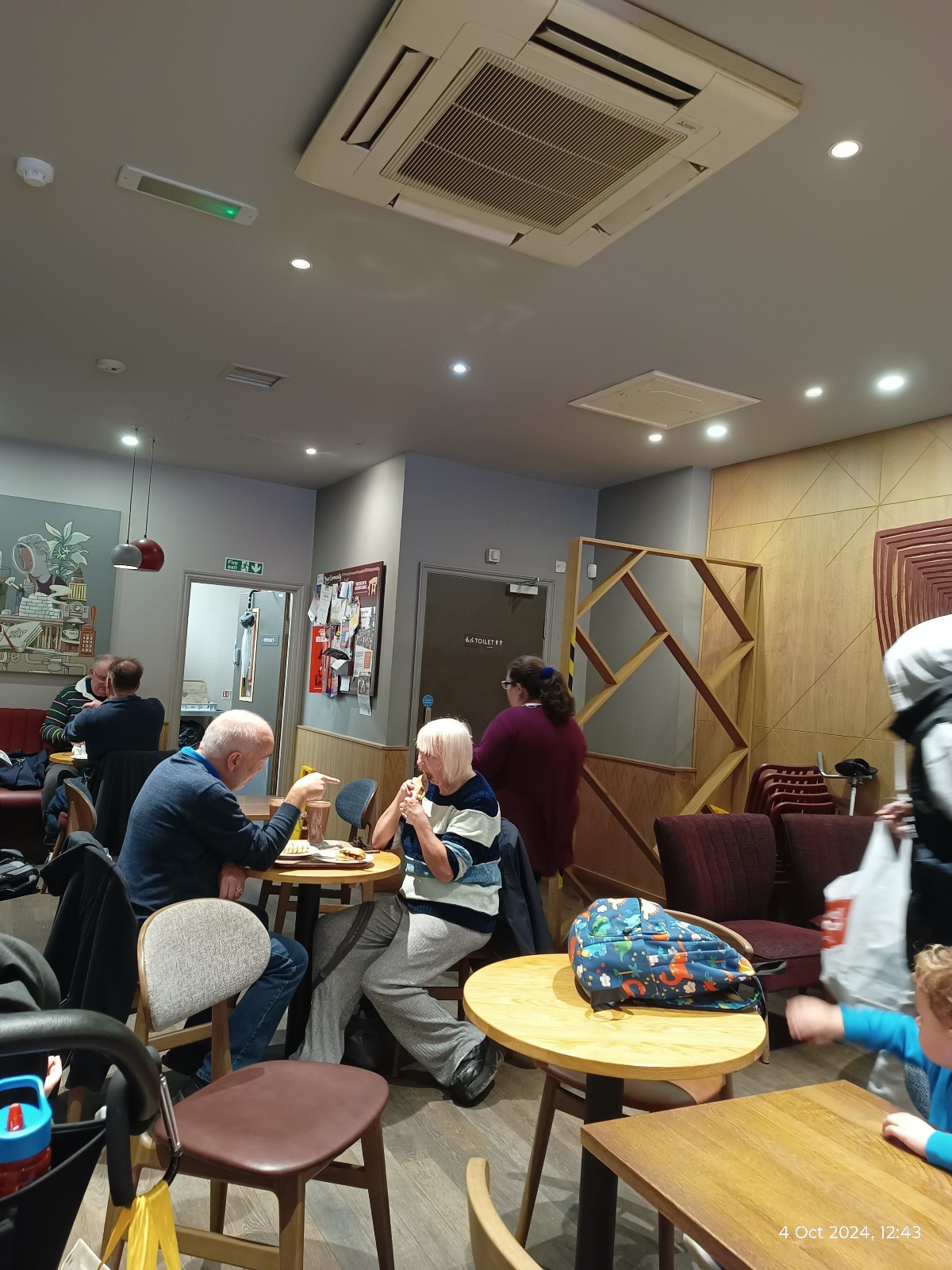 View from the cash register towards the accessible toilet which is in the far right corner. Quite difficult to reach if busy. No lowered counters.