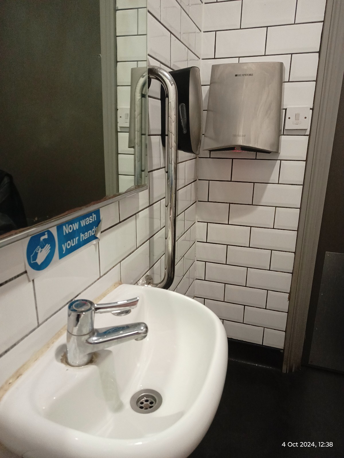 Wheelchair height sink, soap a little too high, hand dryer ok but awkward in the corner. Not a lot of room for turning. Emergency pull cord.