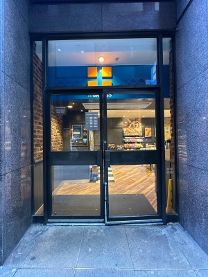 Glass doors with black frames. Black handles in centre, pull to open.