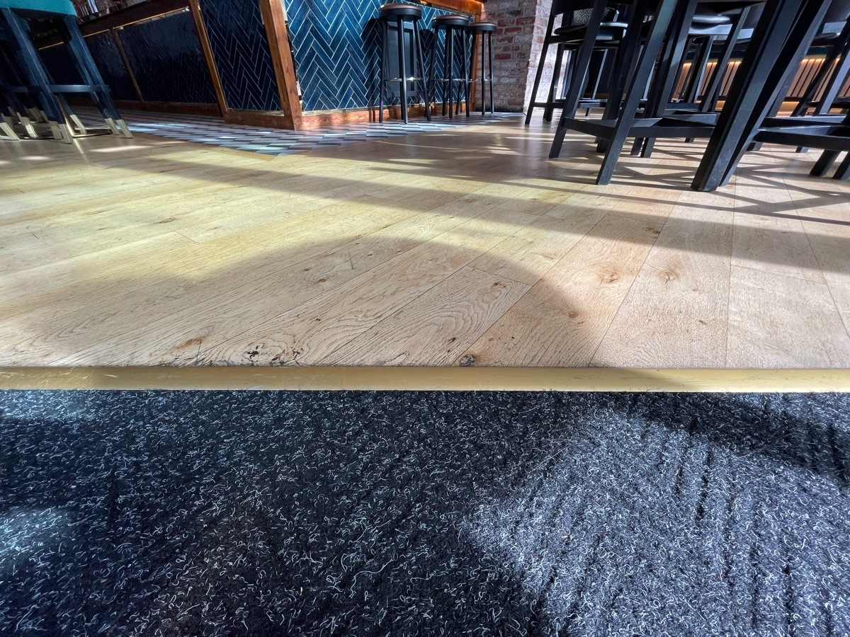 Metal bump along end of doormat.