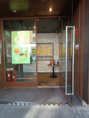 Glass door with silver, metal, vertical handle along left. Pull to open.