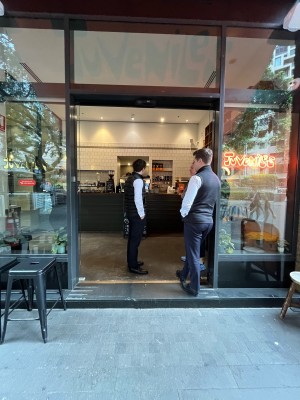Glass doors slide open automatically from middle.