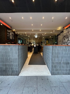 Built in ramp through open archway to doors ahead.
