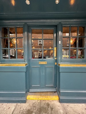 Blue and glass panelled door. Gold panel on right, push to open.