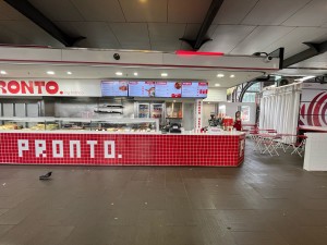 No door leading to service counter ahead. Seating area to right of counter.