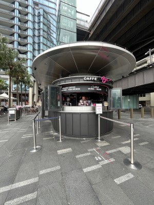 No door leading to service counter ahead. Dividers either side of counter. Path to seating area to left of counter.