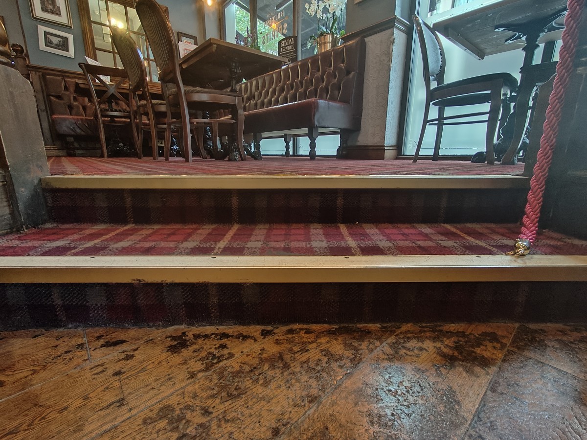 Two steps up before seating. Wooden railings on either sides.