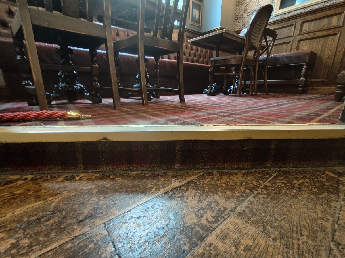 One step up before seating. Wooden railing on either sides of step.