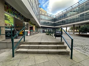 From left of venue, facing right. Stairs ahead. Green handrails on both sides.