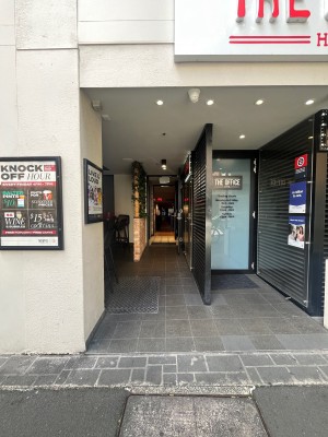 Path to entrance from street. Open archway followed by door ahead.