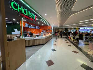 From second floor of shopping centre facing venue. No door, counter immediately at entrance.