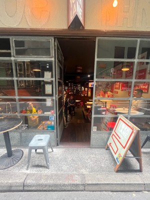 Glass door with grey metal frame. Push from right.