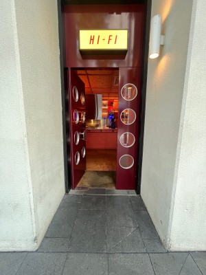 Brown wooden door with glass panels. Push from right.