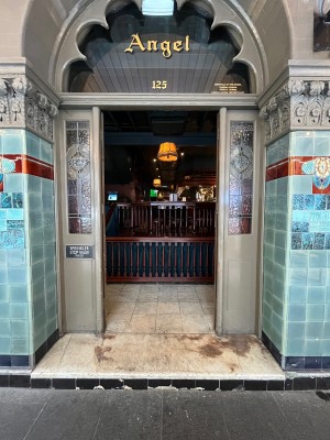 Glass double doors with grey wooden frame. Push from middle.