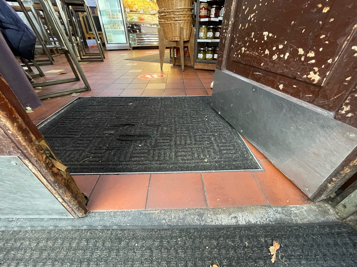Black doormat immediately after door.