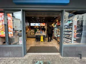 Glass doors with grey frames. Grey handles in centre, push to open.