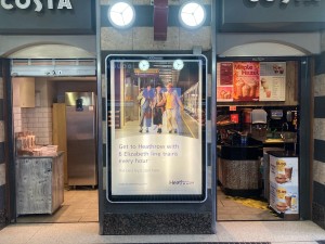 From sidewalk inside the station, facing venue. Two open arches ahead.