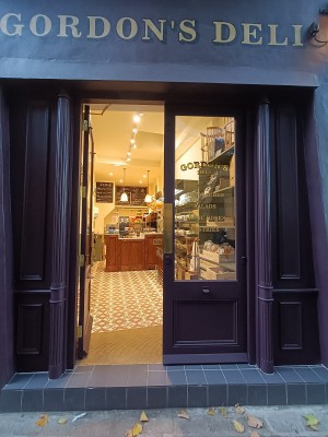 Glass doors with purple frames. Golden, metal pads in middle. Push to open.