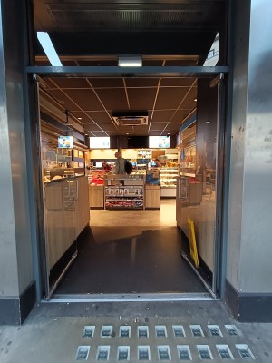 Glass doors with silver, metal handle in the middle. Push to open.