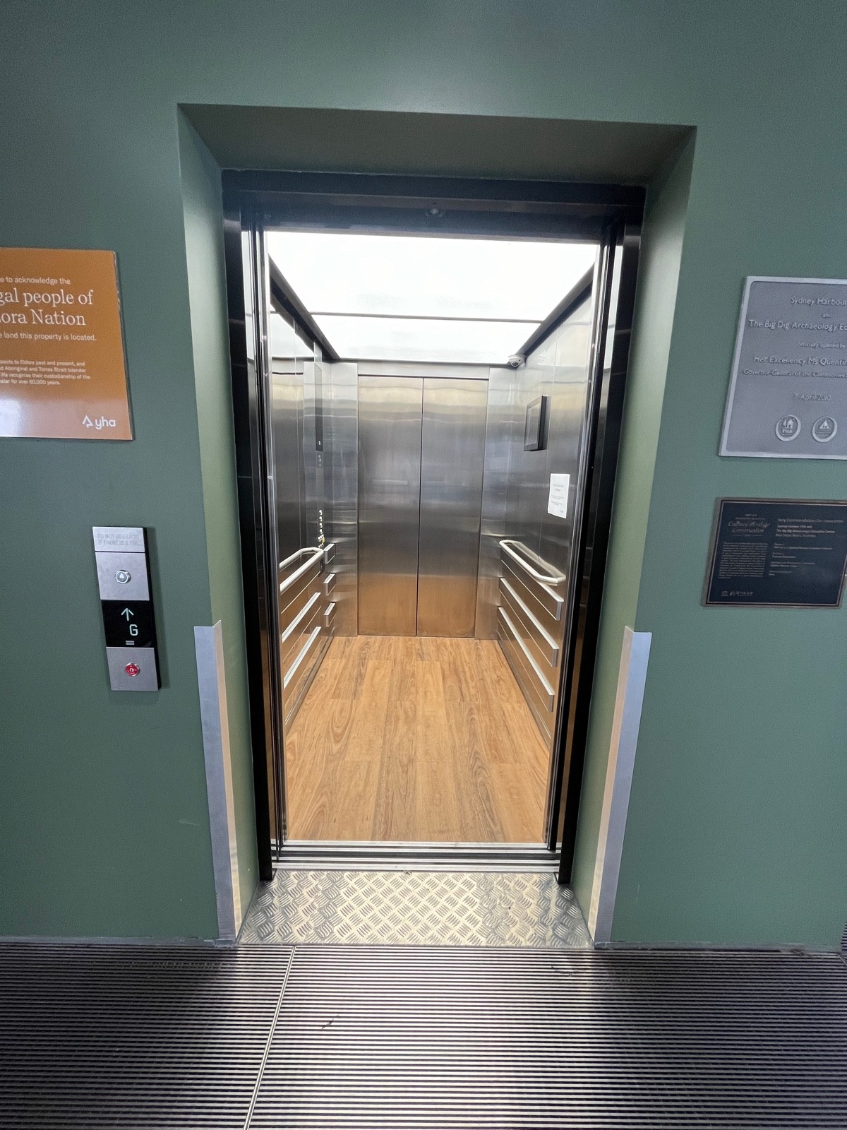 Lift to main area. Call button on wall to left. Doors open from middle.