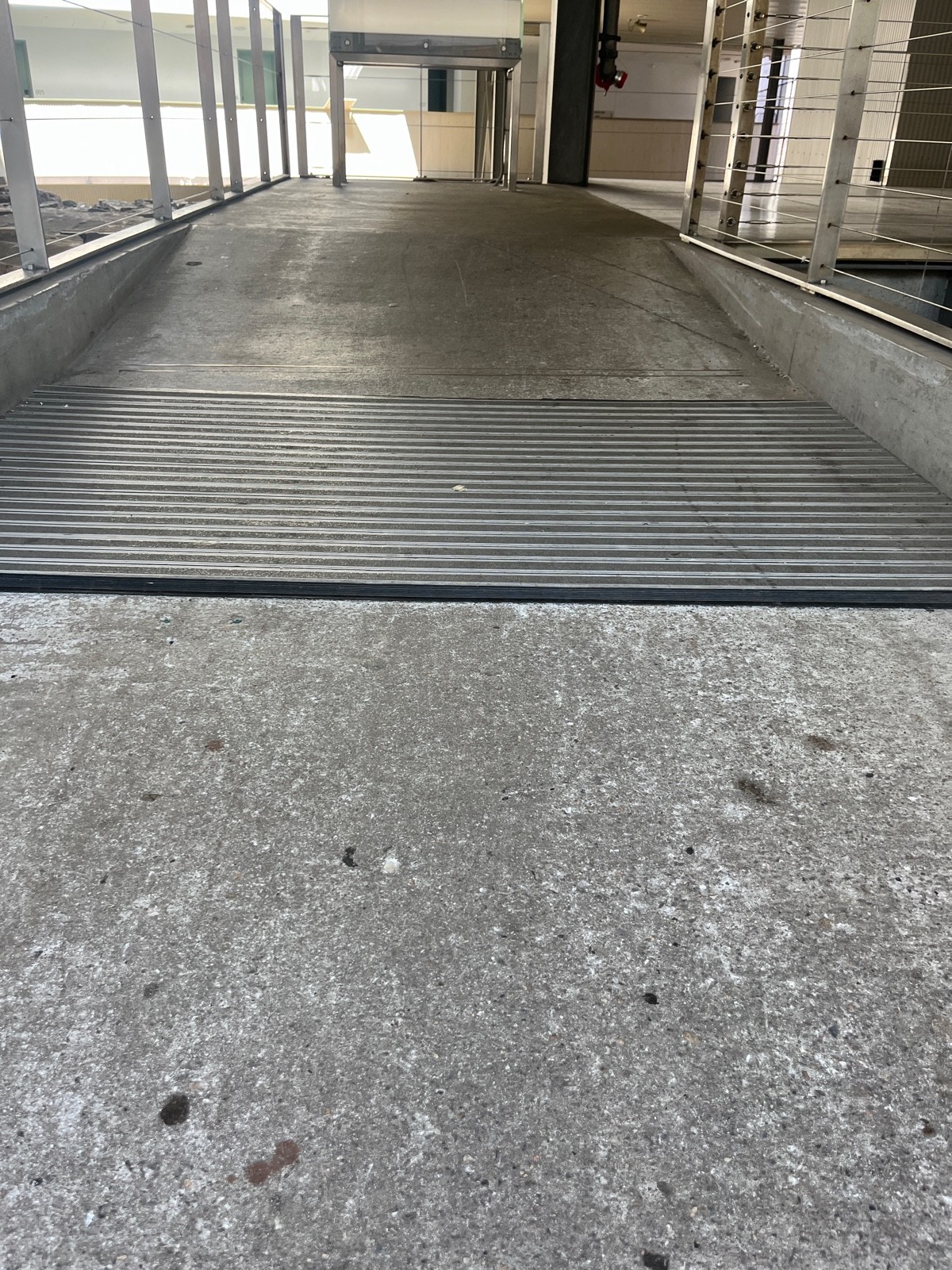 Small bump at foot of doors followed by doormat and built in ramp up.