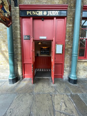 Red wooden and glass doors ahead. Gold metal handles to centre. Pull to open.
