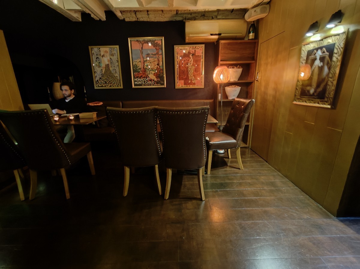 From end of half booths straight from stairs facing left. Half booths along back wall.