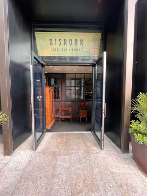 Double glass doors in black metal frames. Pull copper handles from centre.