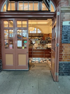 Facing brown-framed double glass doors. Use knobs in centre to slide doors from centre. Door folds open.