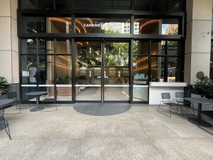 Path to entrance from street. Doors directly ahead through outdoor seating.