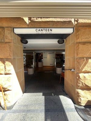 Open archway to doors directly ahead. Two steps down through archway. Handrail on right.